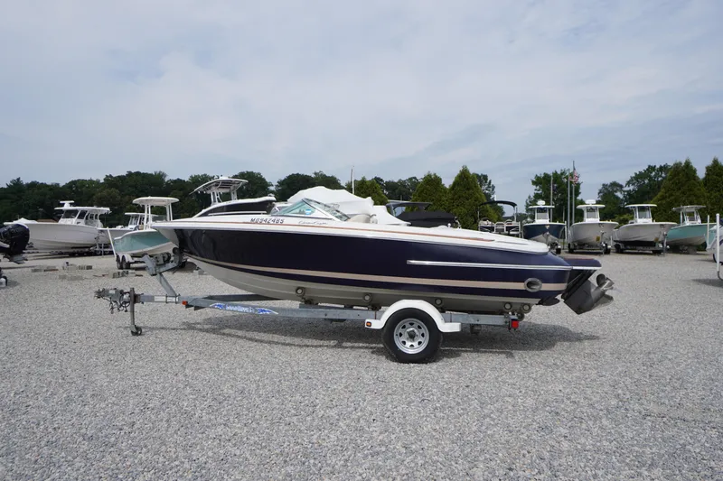 The Image of 2005 Chris Craft Speedster Heritage boat on trailer in a marina setting. - 0