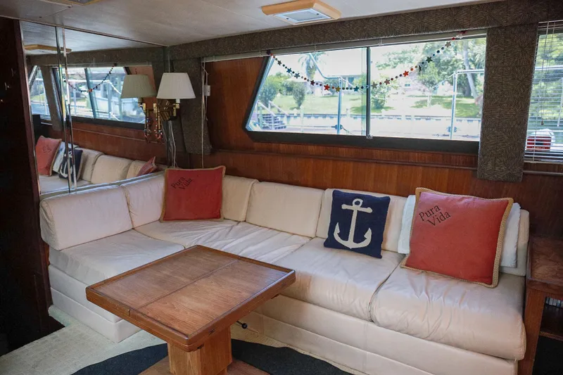 Slide: The Image of Interior of 1987 Hatteras 40 Double Cabin with cozy seating and nautical decor. - 53