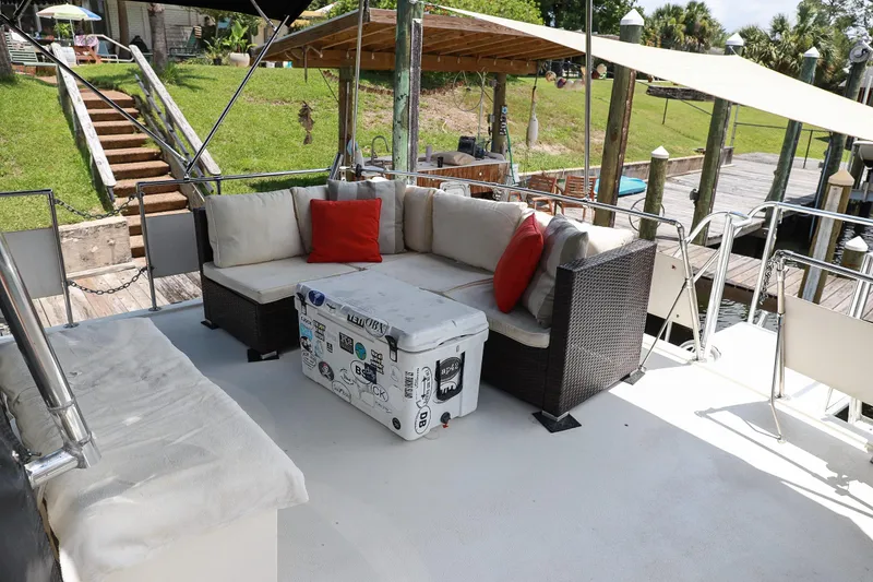 Slide: The Image of Outdoor seating area on 1987 Hatteras 40 Double Cabin yacht with cushions and cooler. - 11