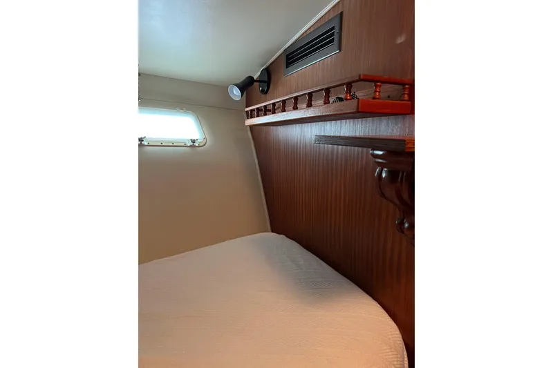 Slide: The Image of Interior of 1987 Hatteras 40 Double Cabin with wood paneling and bed. - 29