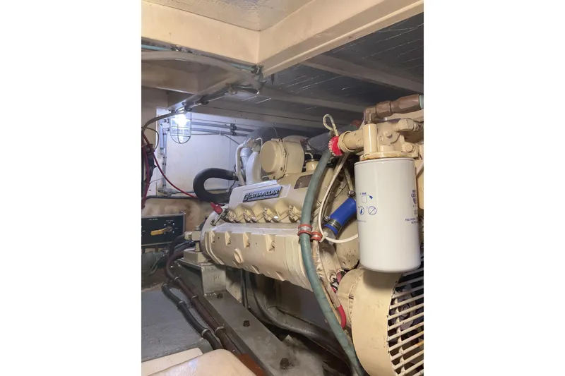 Slide: The Image of Engine room of a 1987 Hatteras 40 Double Cabin yacht, featuring a Caterpillar engine. - 16