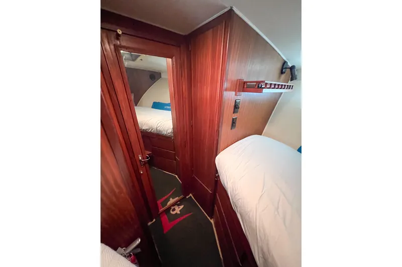 Slide: The Image of Interior of 1987 Hatteras 40 Double Cabin with wooden paneling and cozy bedding. - 31