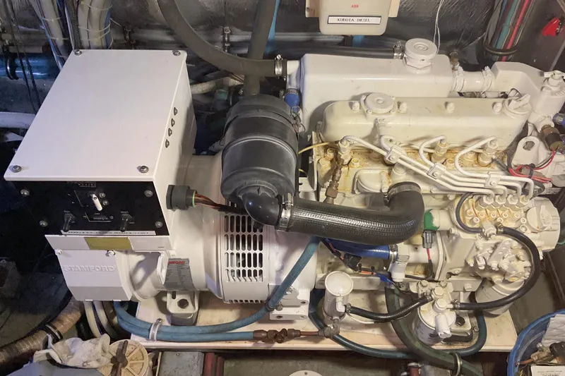 Slide: The Image of Engine room of a 1987 Hatteras 40 Double Cabin with generator and wiring. - 13