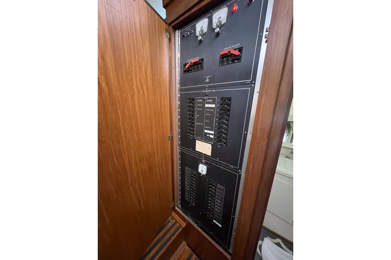 Slide: The Image of Electrical panel inside 1987 Hatteras 40 Double Cabin yacht, featuring switches and meters. - 37