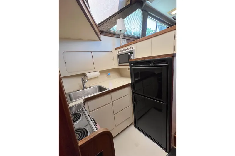 Slide: The Image of Compact kitchen in a 1987 Hatteras 40 Double Cabin yacht with modern appliances. - 43