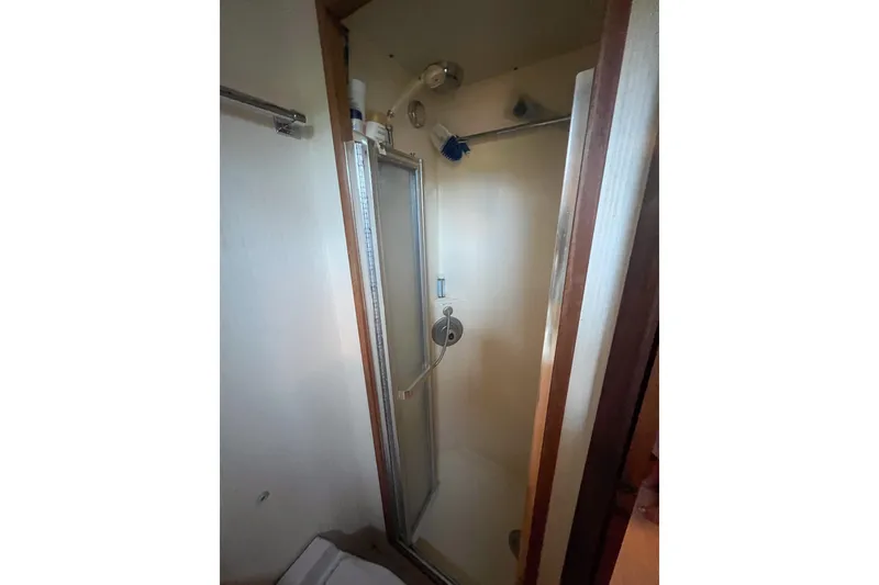 Slide: The Image of Shower area in 1987 Hatteras 40 Double Cabin yacht, featuring a compact design. - 26