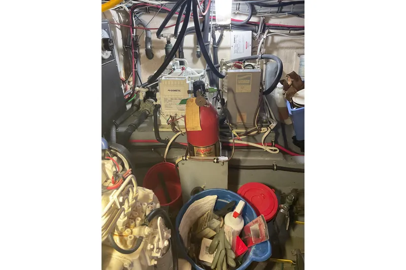 Slide: The Image of Engine room of 1987 Hatteras 40 Double Cabin with equipment and tools. - 11
