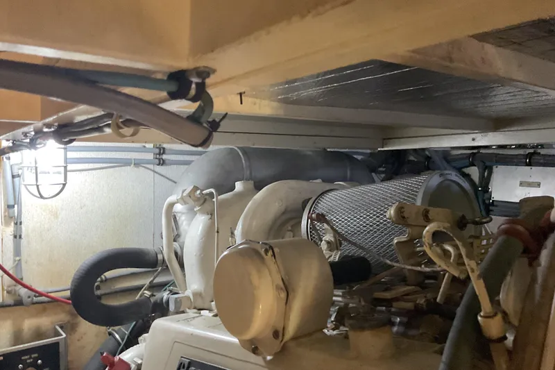 Slide: The Image of Engine room of a 1987 Hatteras 40 Double Cabin yacht, showcasing mechanical components. - 17