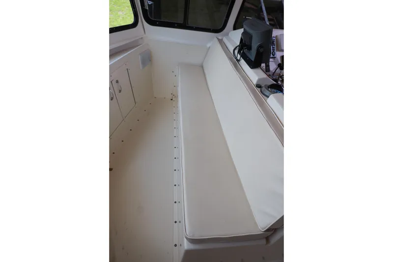 Slide: The Image of Interior seating area of 1987 Hatteras 40 Double Cabin yacht with white cushions. - 63