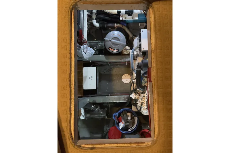 Slide: The Image of Engine room of a 1987 Hatteras 40 Double Cabin yacht, showcasing mechanical components. - 20
