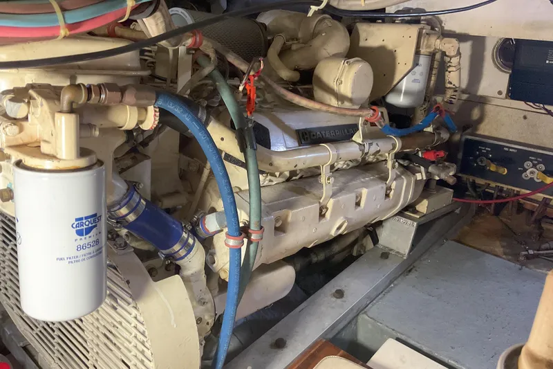 Slide: The Image of Engine room of a 1987 Hatteras 40 Double Cabin with visible Caterpillar engine components. - 15