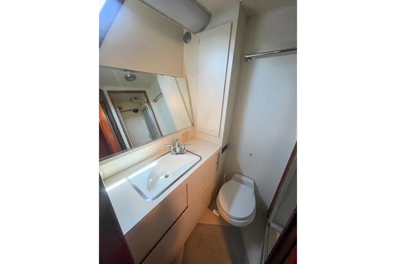 Slide: The Image of Bathroom interior of 1987 Hatteras 40 Double Cabin yacht, featuring sink and toilet. - 25
