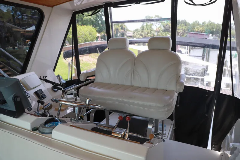 Slide: The Image of Interior helm of 1987 Hatteras 40 Double Cabin with dual leather seats and control panel. - 62