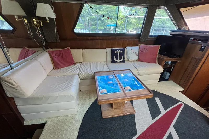 Slide: The Image of Interior of 1987 Hatteras 40 Double Cabin with cozy seating and nautical decor. - 44