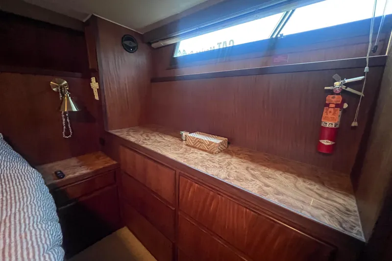 Slide: The Image of 1987 Hatteras 40 Double Cabin interior with wood paneling, lamp, and fire extinguisher. - 27