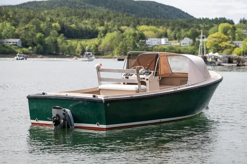 Slide: The Image of 1989 Ellis 24 Open boat on calm water with scenic forested background. - 3