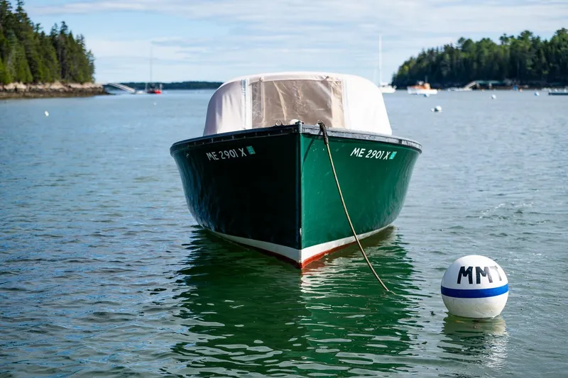 Slide: The Image of 1989 Ellis 24 Open boat moored in scenic harbor with buoy, surrounded by calm waters. - 5