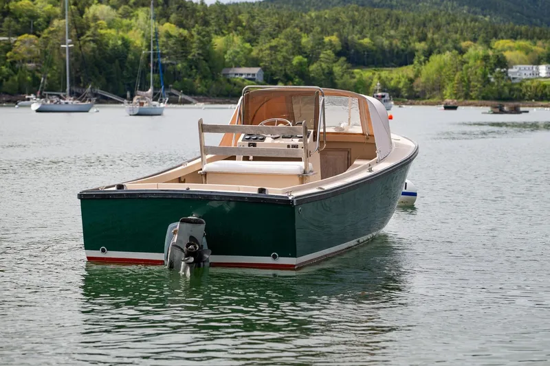 Slide: The Image of 1989 Ellis 24 Open boat on calm water with scenic forested background. - 4