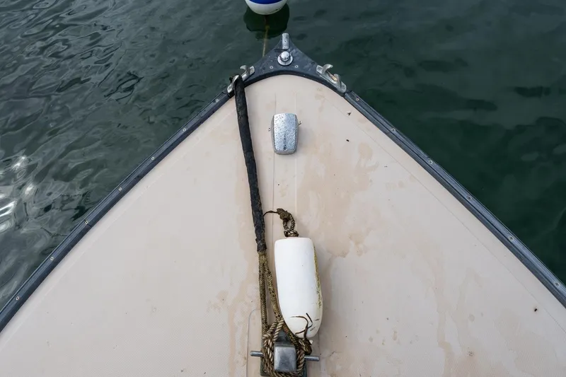 Slide: The Image of Bow of 1989 Ellis 24 Open boat with rope and buoy on water. - 32
