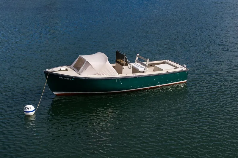 Slide: The Image of 1989 Ellis 24 Open boat moored on calm water with a buoy. - 17