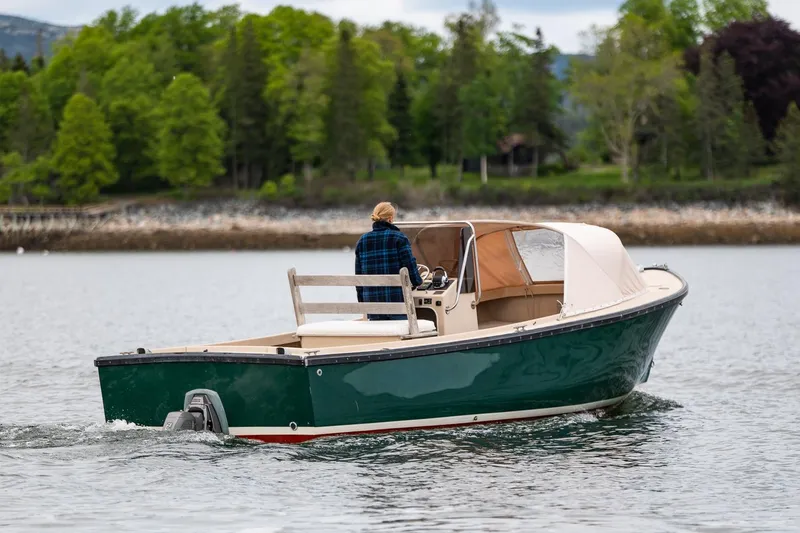 Slide: The Image of 1989 Ellis 24 Open boat cruising on a calm lake with lush green trees. - 11