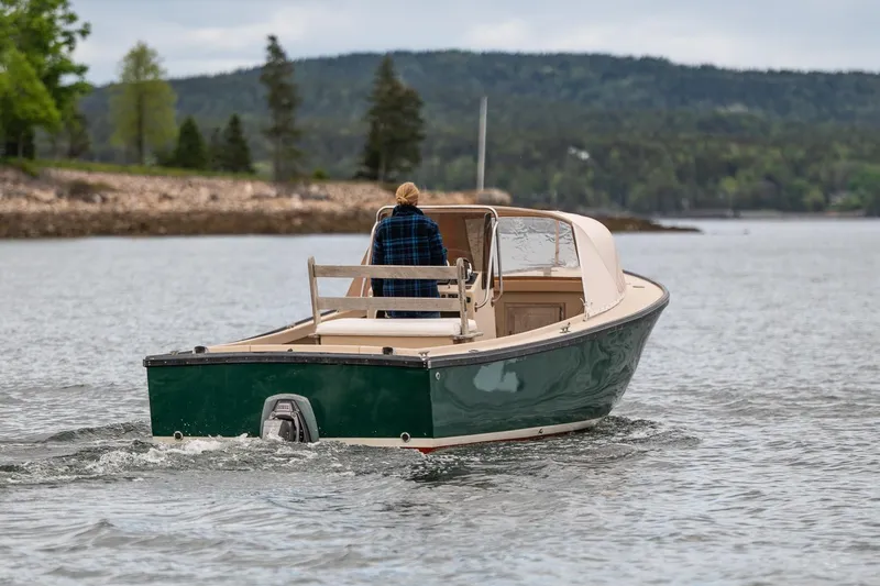 Slide: The Image of 1989 Ellis 24 Open boat cruising on a scenic lake with lush green hills. - 12