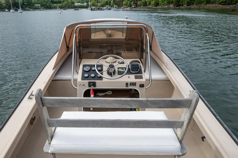 Slide: The Image of 1989 Ellis 24 Open boat interior with steering wheel, dashboard, and lake view. - 24