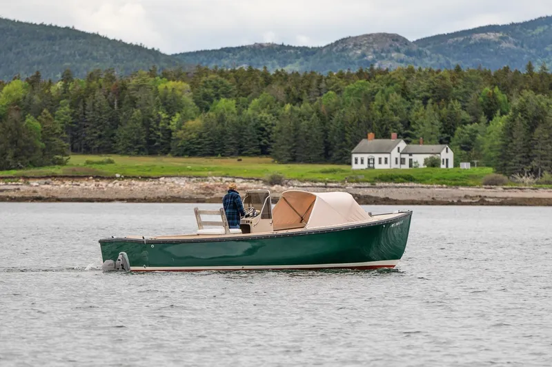 Slide: The Image of 1989 Ellis 24 Open boat cruising on a scenic lake with forested hills in the background. - 43