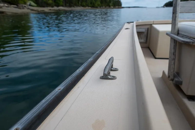 Slide: The Image of 1989 Ellis 24 Open boat on calm water, featuring a cleat on the deck. - 36