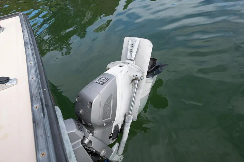 Slide: The Image of Outboard motor on 1989 Ellis 24 Open boat in calm water. - 42