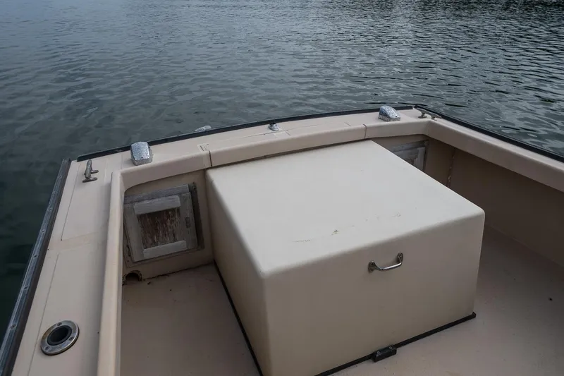 Slide: The Image of 1989 Ellis 24 Open boat interior with storage compartment on calm water. - 39