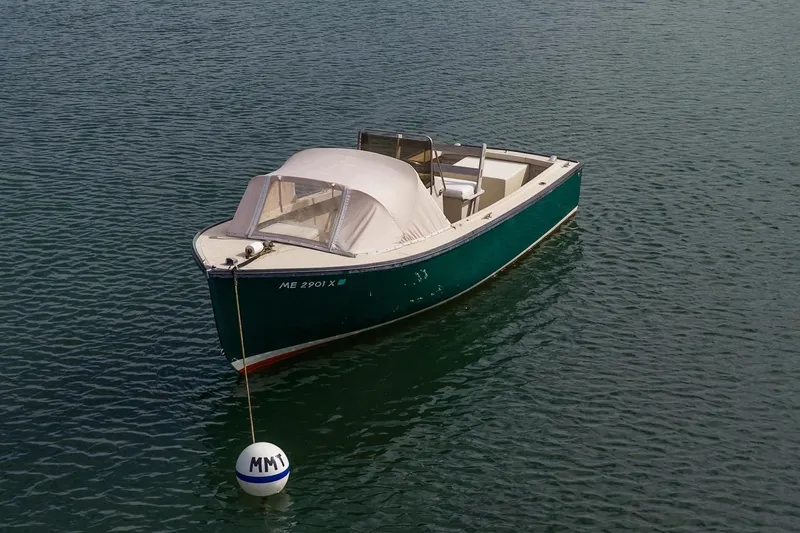 Slide: The Image of 1989 Ellis 24 Open boat moored on calm water with a buoy. - 18