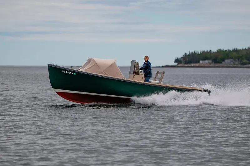 Slide: The Image of 1989 Ellis 24 Open boat cruising on calm waters with a person steering. - 6