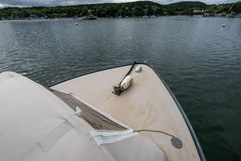 Slide: The Image of Bow view of 1989 Ellis 24 Open boat on calm water, surrounded by lush greenery. - 31