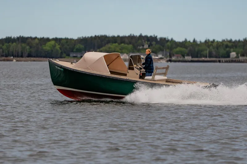 Slide: The Image of 1989 Ellis 24 Open boat cruising on a lake with a person steering. - 8