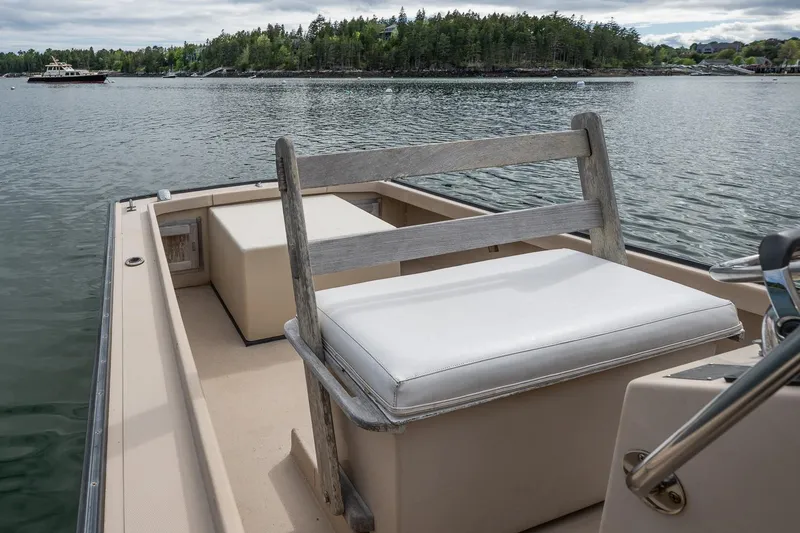 Slide: The Image of 1989 Ellis 24 Open boat with white seating, on calm water with scenic background. - 37