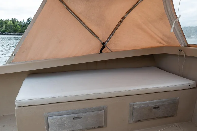 Slide: The Image of Cushioned seating area on 1989 Ellis 24 Open boat with canopy and storage drawers. - 30