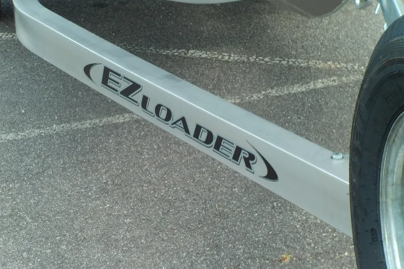 Slide: The Image of EZ Loader trailer for 2026 Stabicraft 1450 Explorer on asphalt surface. - 11