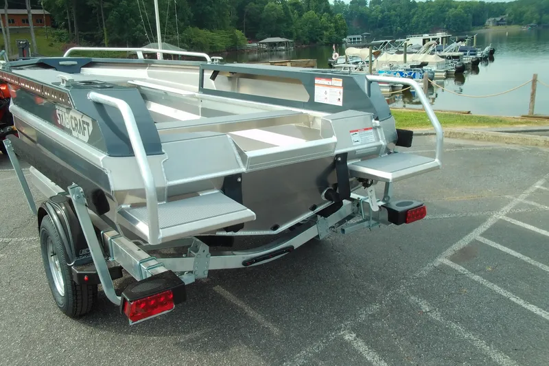 Slide: The Image of 2026 Stabicraft 1450 Explorer boat on trailer near a scenic lake. - 12