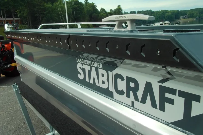 Slide: The Image of 2026 Stabicraft 1450 Explorer boat, close-up view with logo and sleek design. - 13