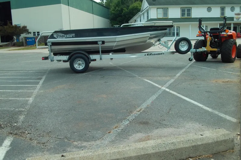 Slide: The Image of 2026 Stabicraft 1450 Explorer boat on trailer, parked in a lot. - 2