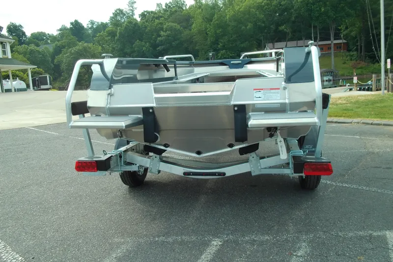 Slide: The Image of 2026 Stabicraft 1450 Explorer boat on trailer, parked outdoors near trees. - 3