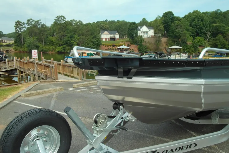 Slide: The Image of 2026 Stabicraft 1450 Explorer boat on trailer at scenic lakeside dock. - 4