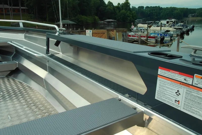 Slide: The Image of 2026 Stabicraft 1450 Explorer boat interior with safety warnings, docked near other boats. - 7