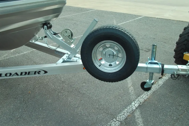 Slide: The Image of Trailer hitch and spare tire of 2026 Stabicraft 1450 Explorer in parking lot. - 9