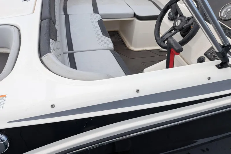 Slide: The Image of 2023 Bayliner Element M17 boat interior with steering wheel and seating area. - 3