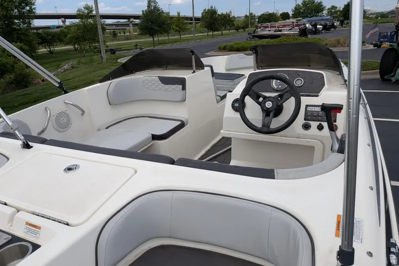 Slide: The Image of 2023 Bayliner Element M17 boat interior with steering wheel and seating area. - 4