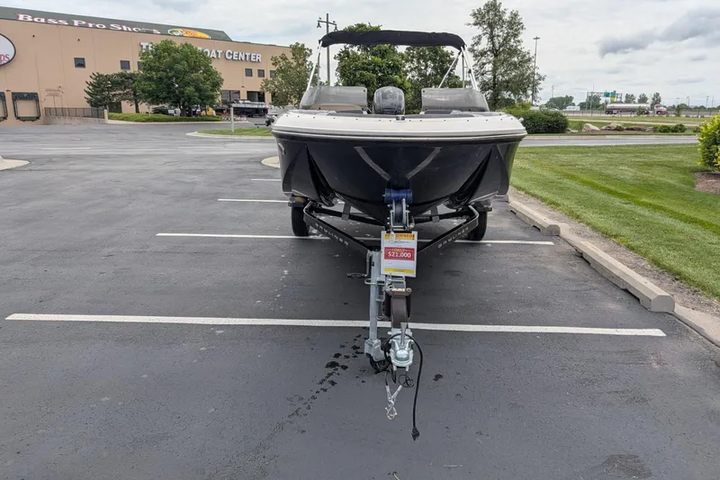 Slide: The Image of 2023 Bayliner Element M17 boat on trailer, parked in lot near Bass Pro Shops. - 6