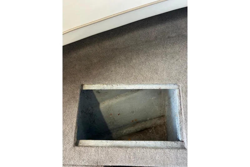 Slide: The Image of Open storage compartment in 1999 Bayliner 1954 Capri boat interior. - 26