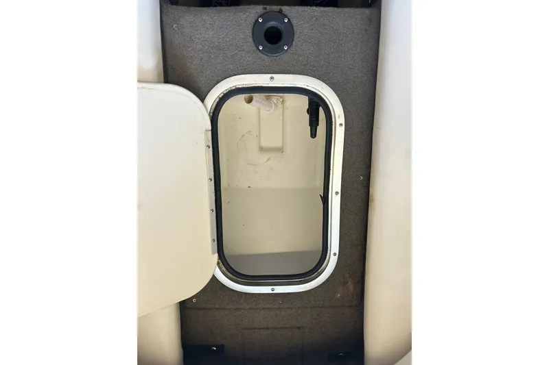 Slide: The Image of Open storage compartment on a 1999 Bayliner 1954 Capri boat. - 18